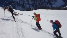 Skitourengruppe im Aufstieg. Eine Person macht die Spitzkehre.